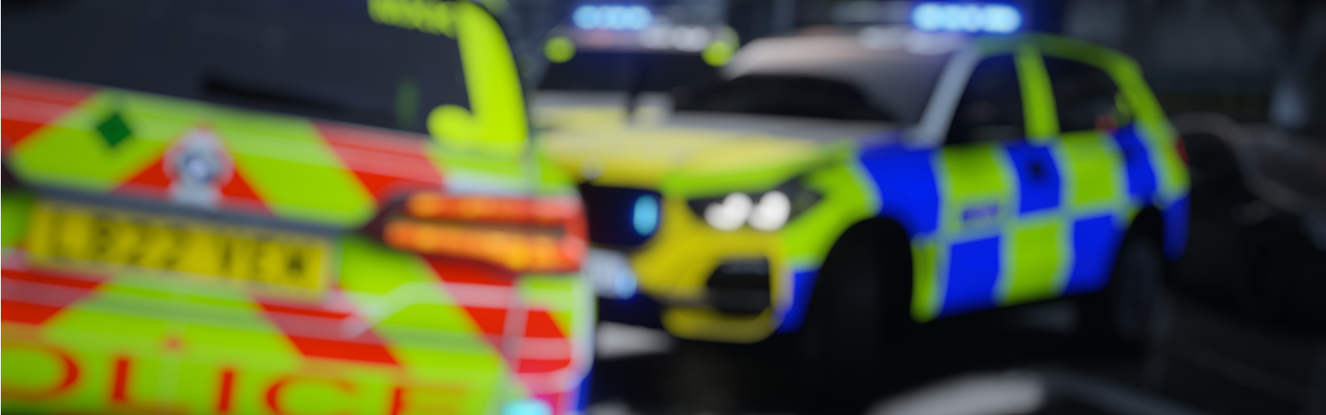 Two police vehicles with flashing lights on a reflective surface.